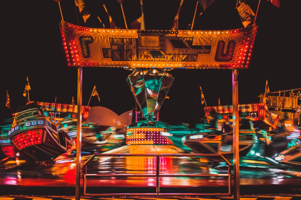 Illuminated waltzer ride at a funfair at night